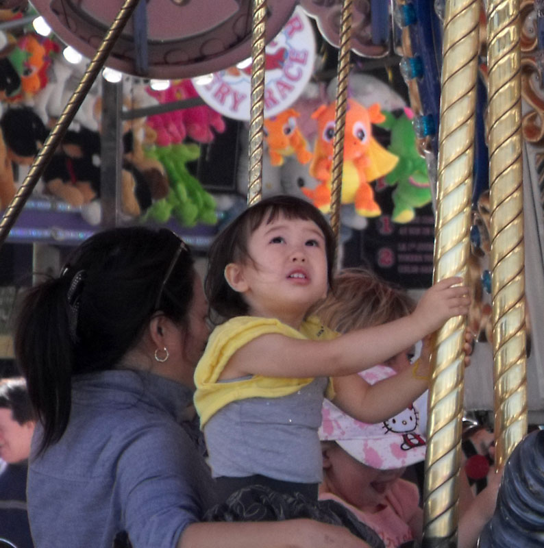little girl on the merry go round
